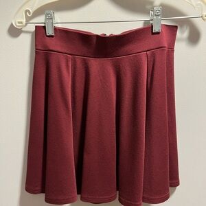Cute H&M skirt wine or maroon color. Wide waist band zip back